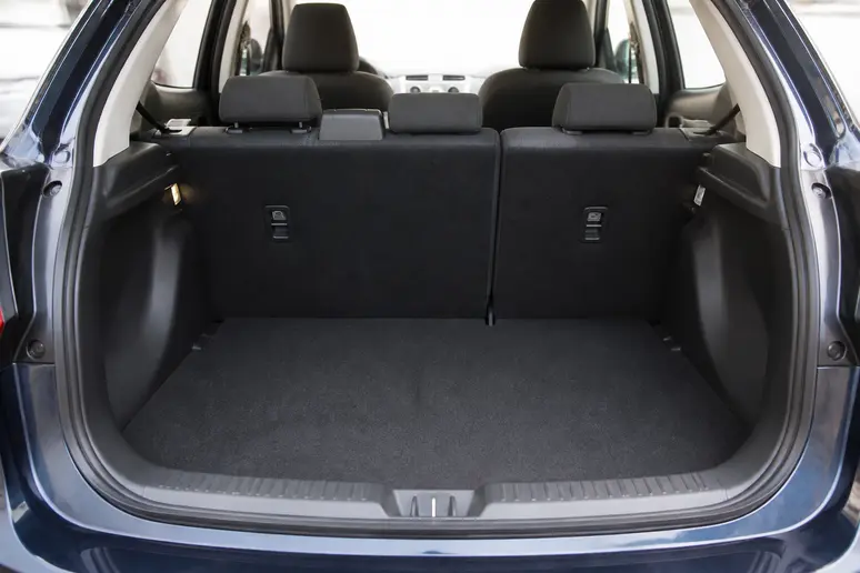 Coffre d'une berline compacte familiale illustrant les limites d'espace pour un aménagement de camping-car.